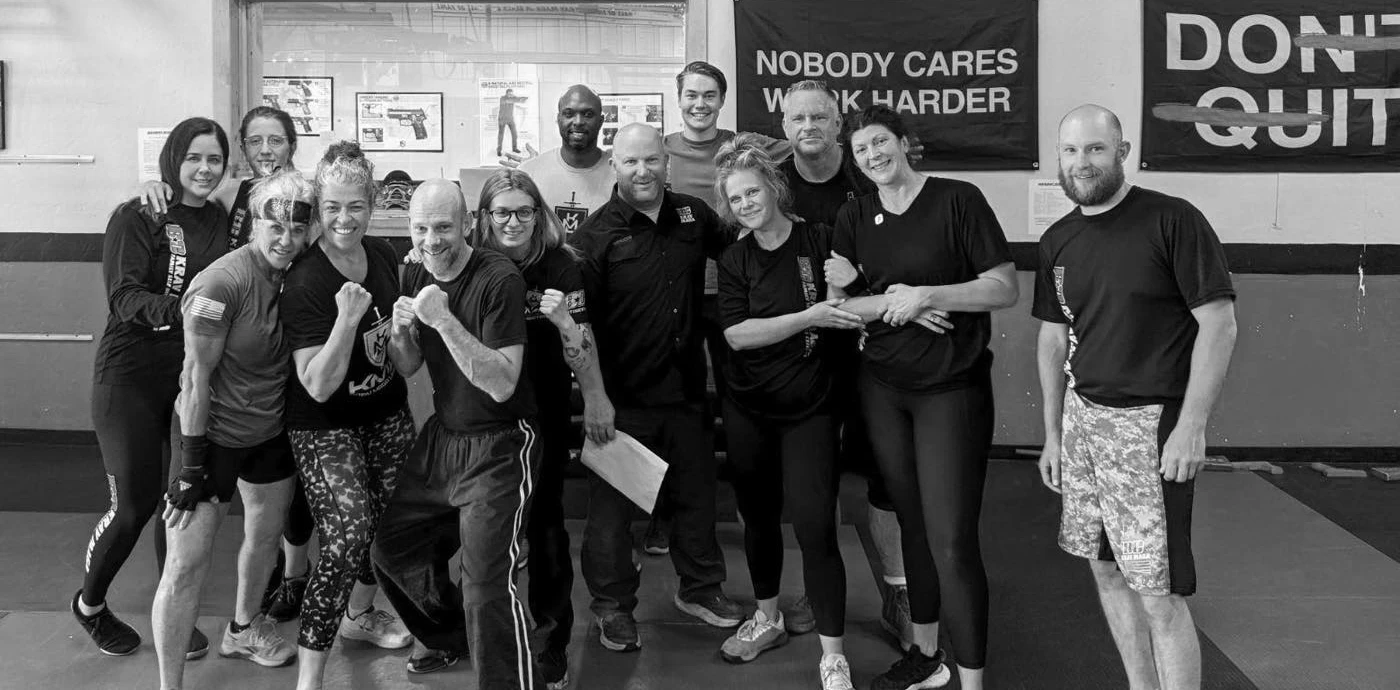 Krav Maga students smiling after a successful belt test, demonstrating the dedication and hard work required to achieve their goals at Boise Cities Krav Maga.