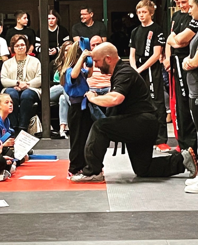 Kids martial arts testing and belt promotion ceremony.